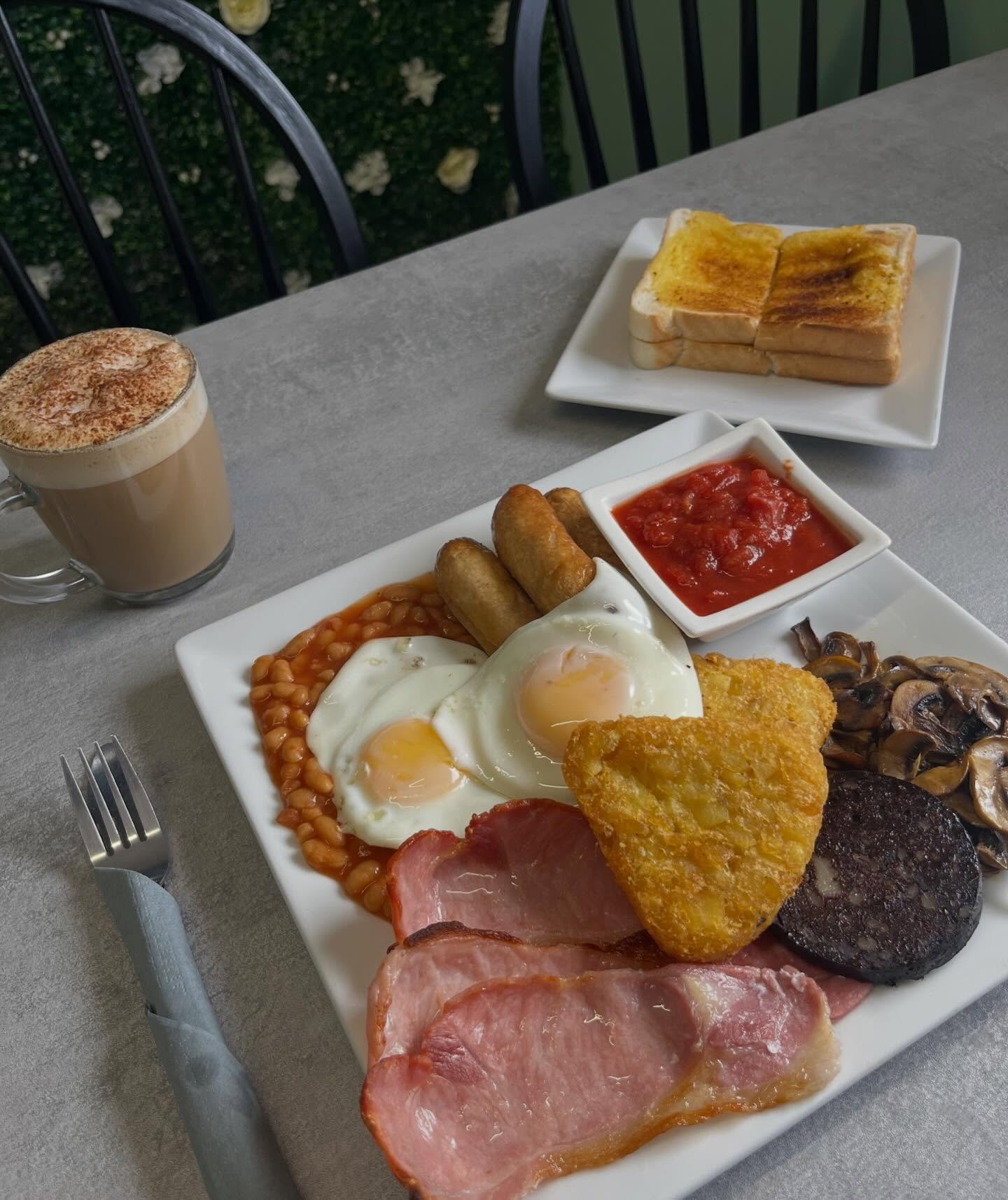 Full English breakfast served with a latte and buttered toast at The Oven Door Cafe in Haydock, St Helens